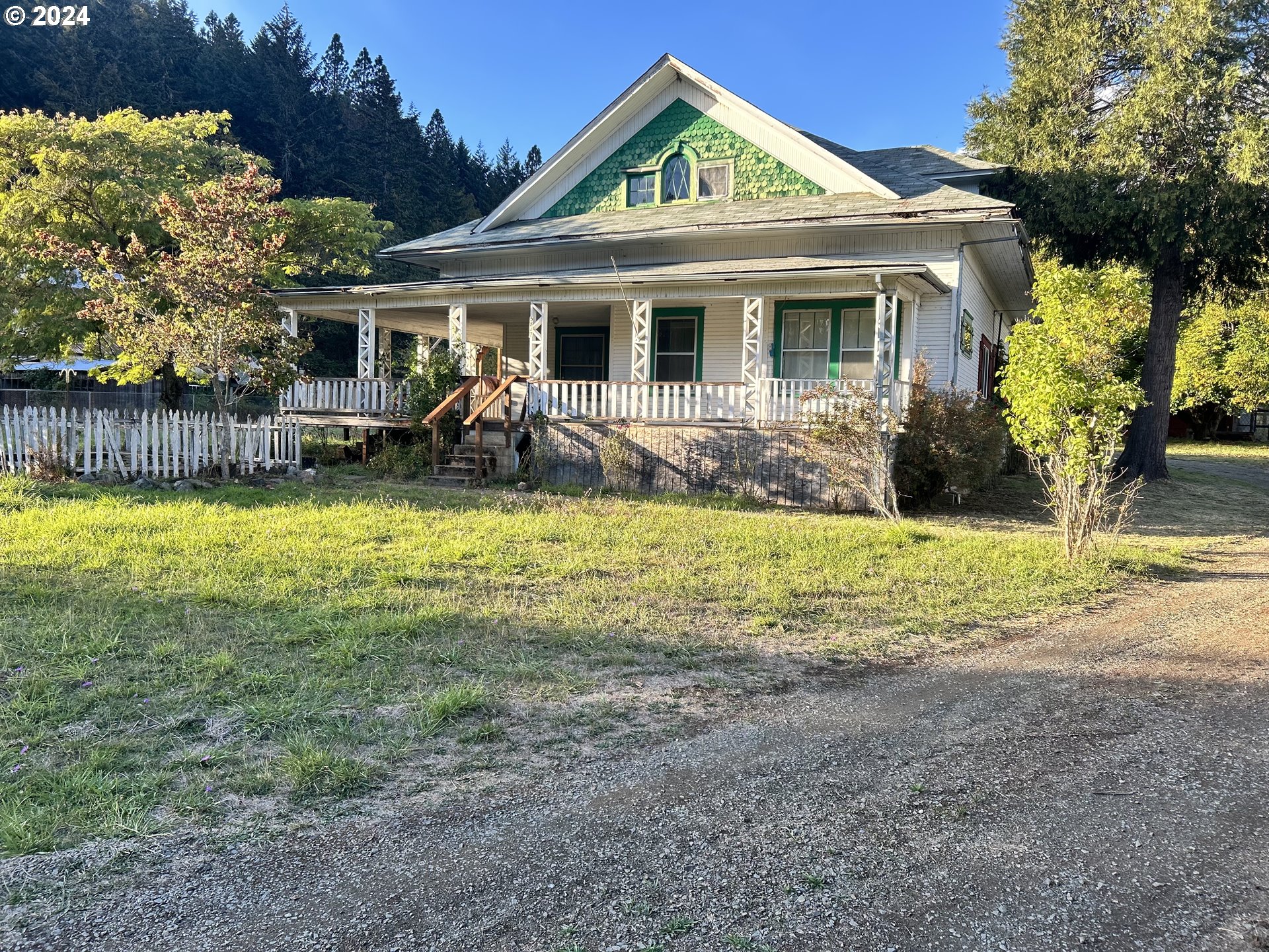 a view of a house with swimming pool and porch