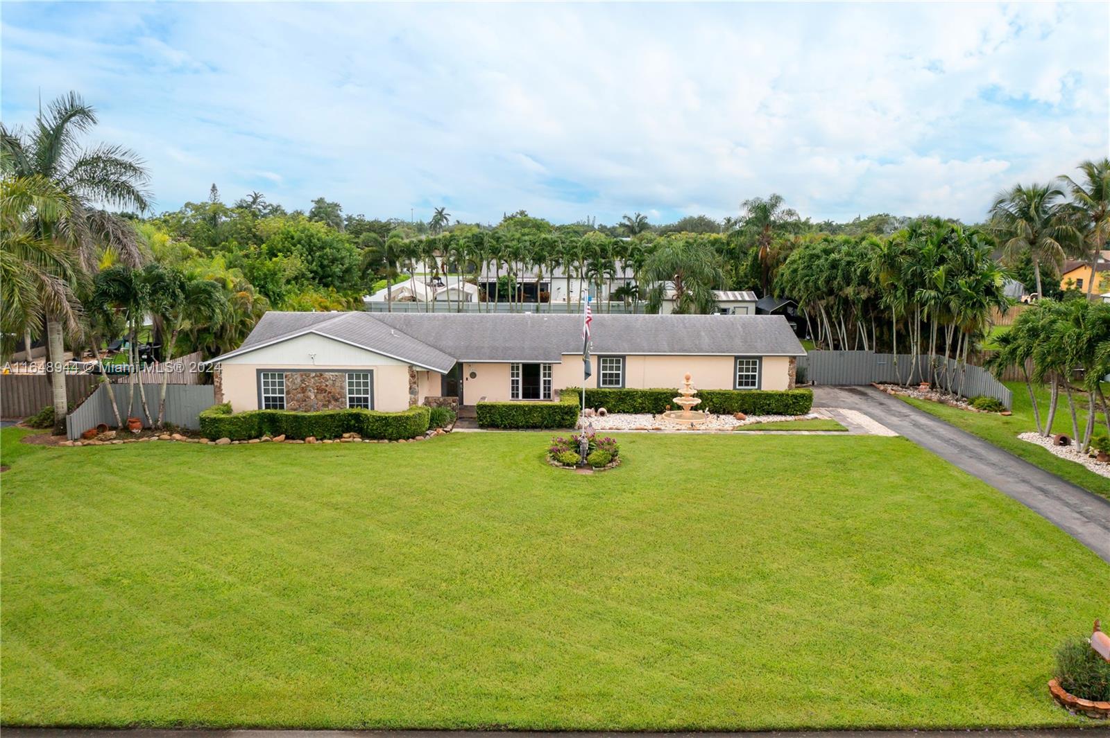 a aerial view of a house with swimming pool and yard