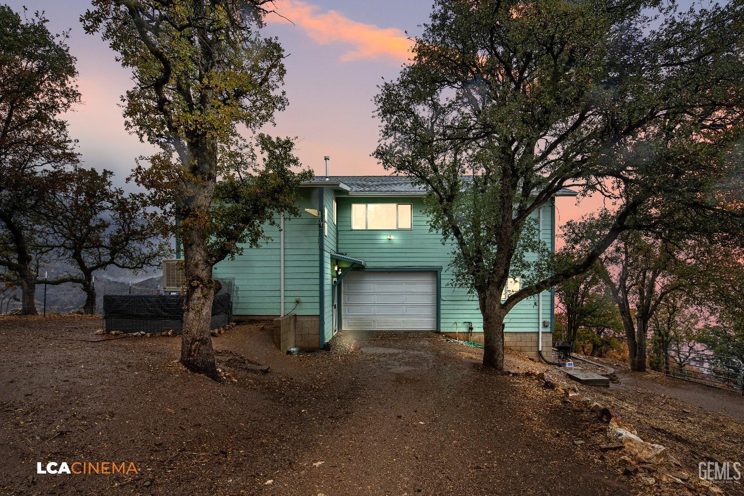 a view of a house with a tree beside it