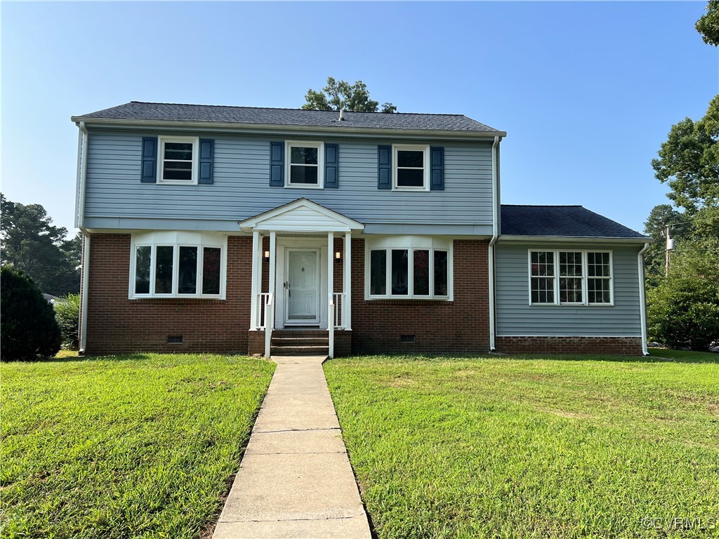 a front view of a house with yard and green space