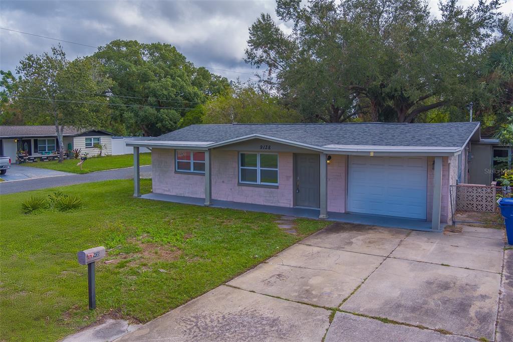 a view of a house with a backyard