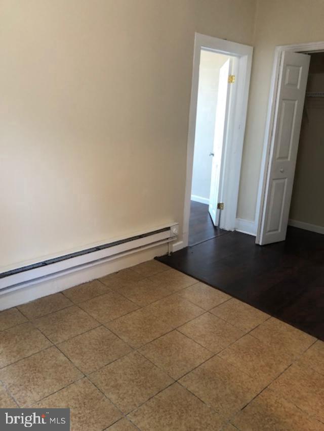 a view of a room with wooden floor and door