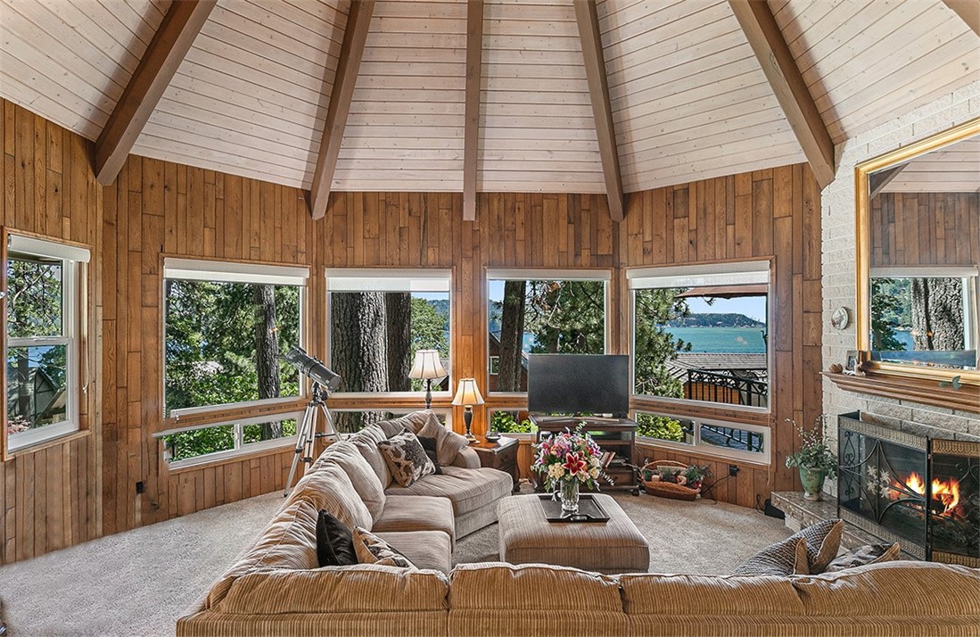 a living room with furniture a fireplace and windows