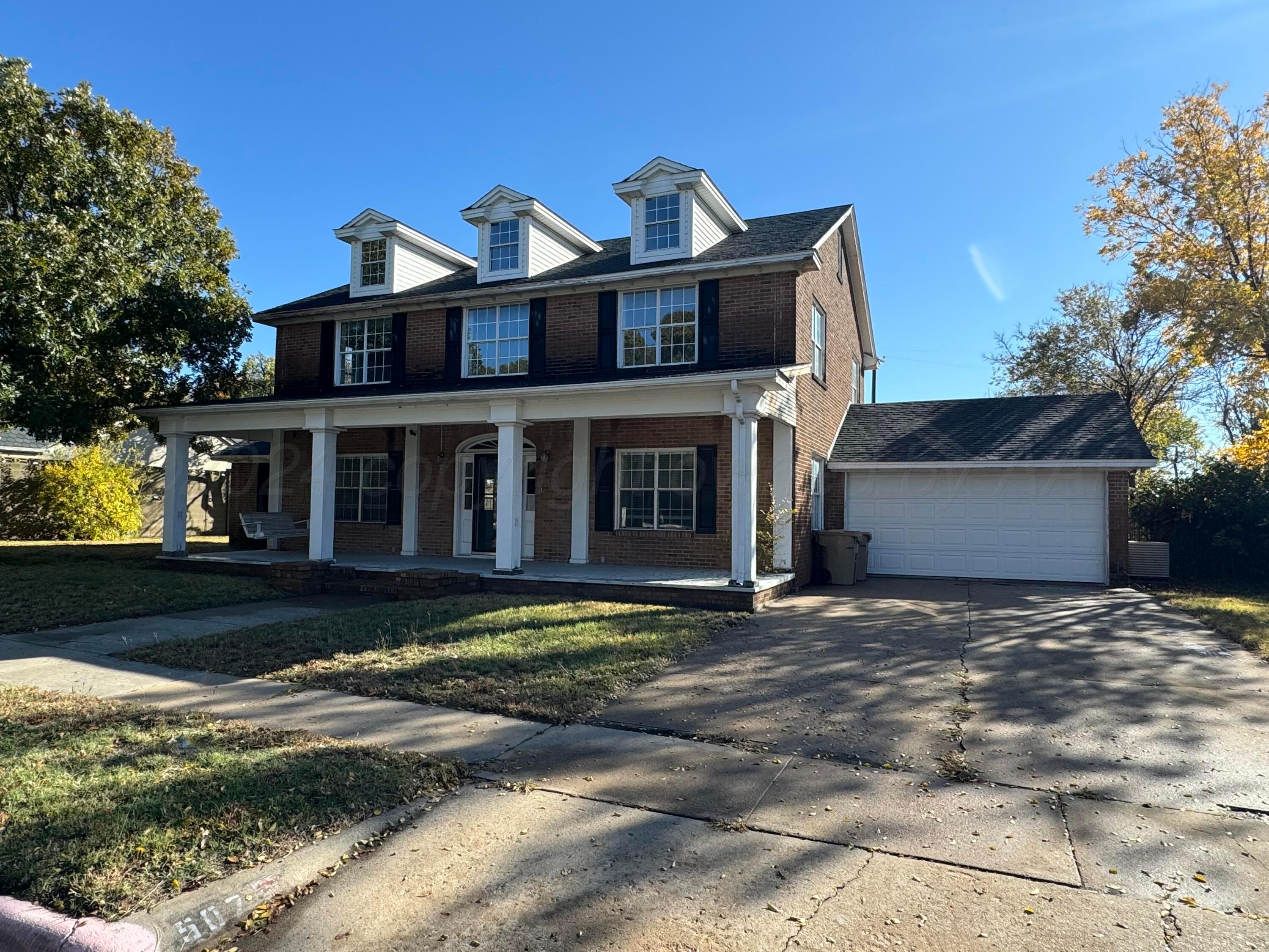 a view of a house with a yard in front of it