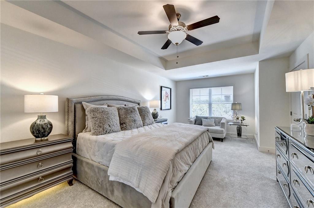 a bedroom with a bed a chandelier and a window