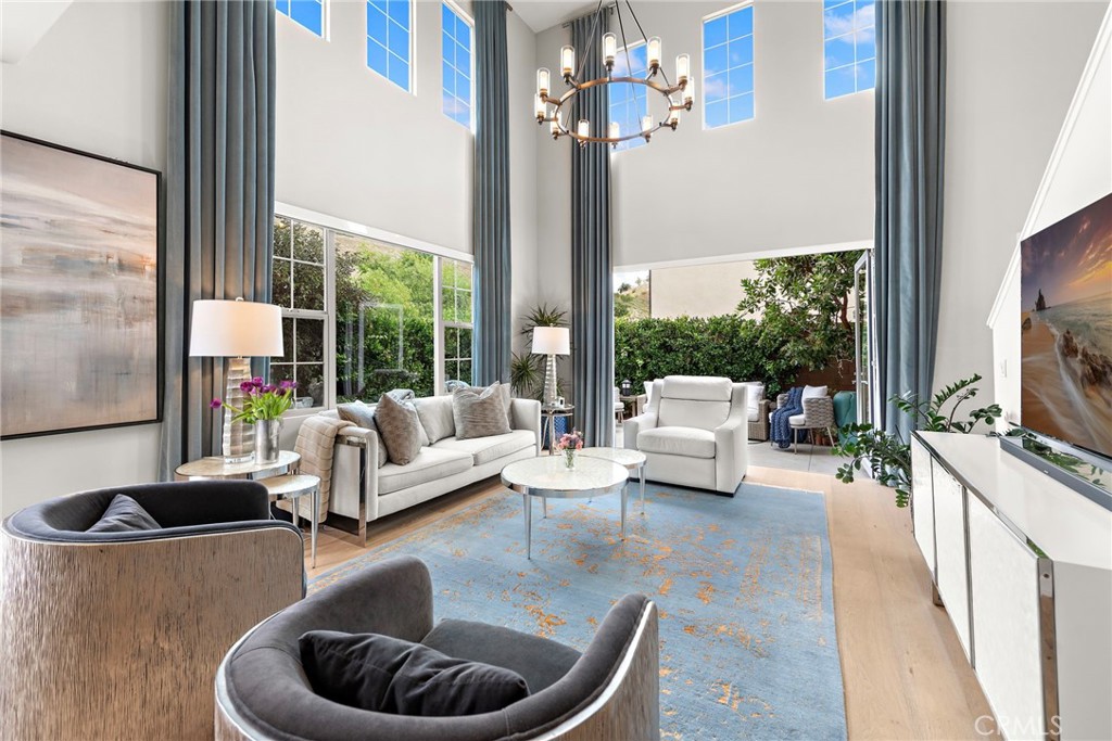 a living room with furniture fireplace and a large window