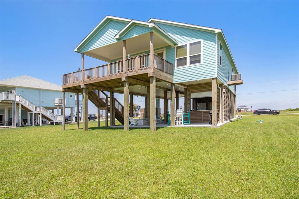 a view of a house with a yard and sitting area