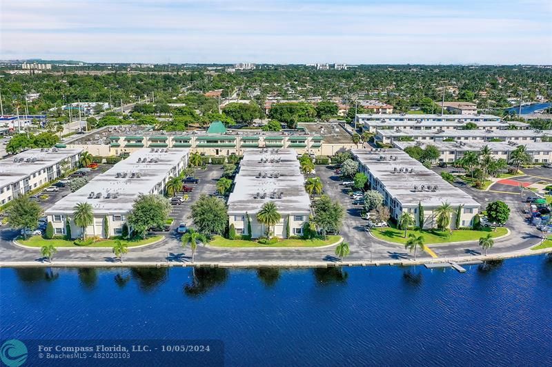 an aerial view of residential houses with outdoor space and river