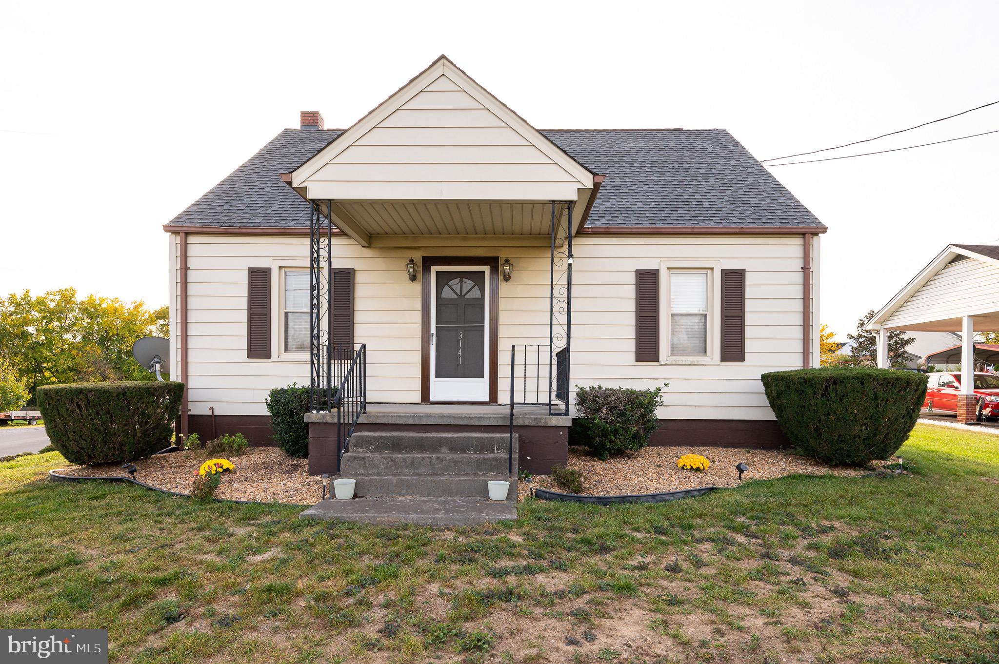 a front view of a house with sitting area