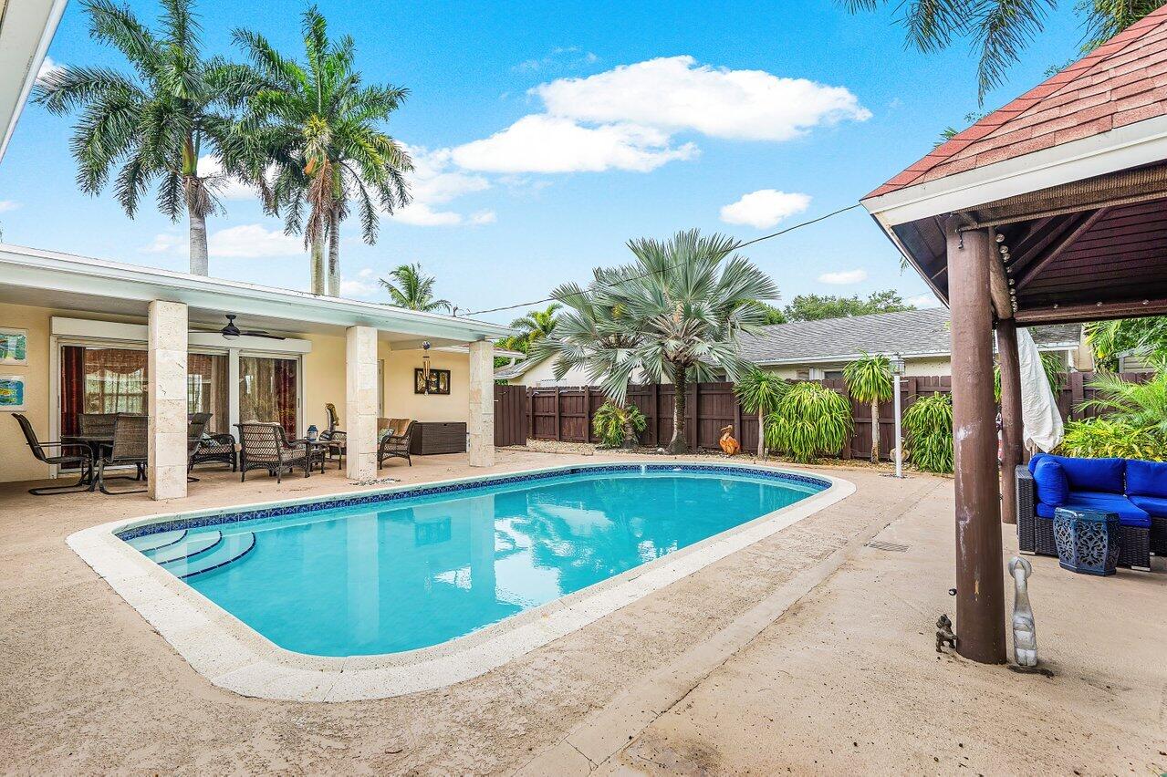 a view of a house with swimming pool and porch with furniture