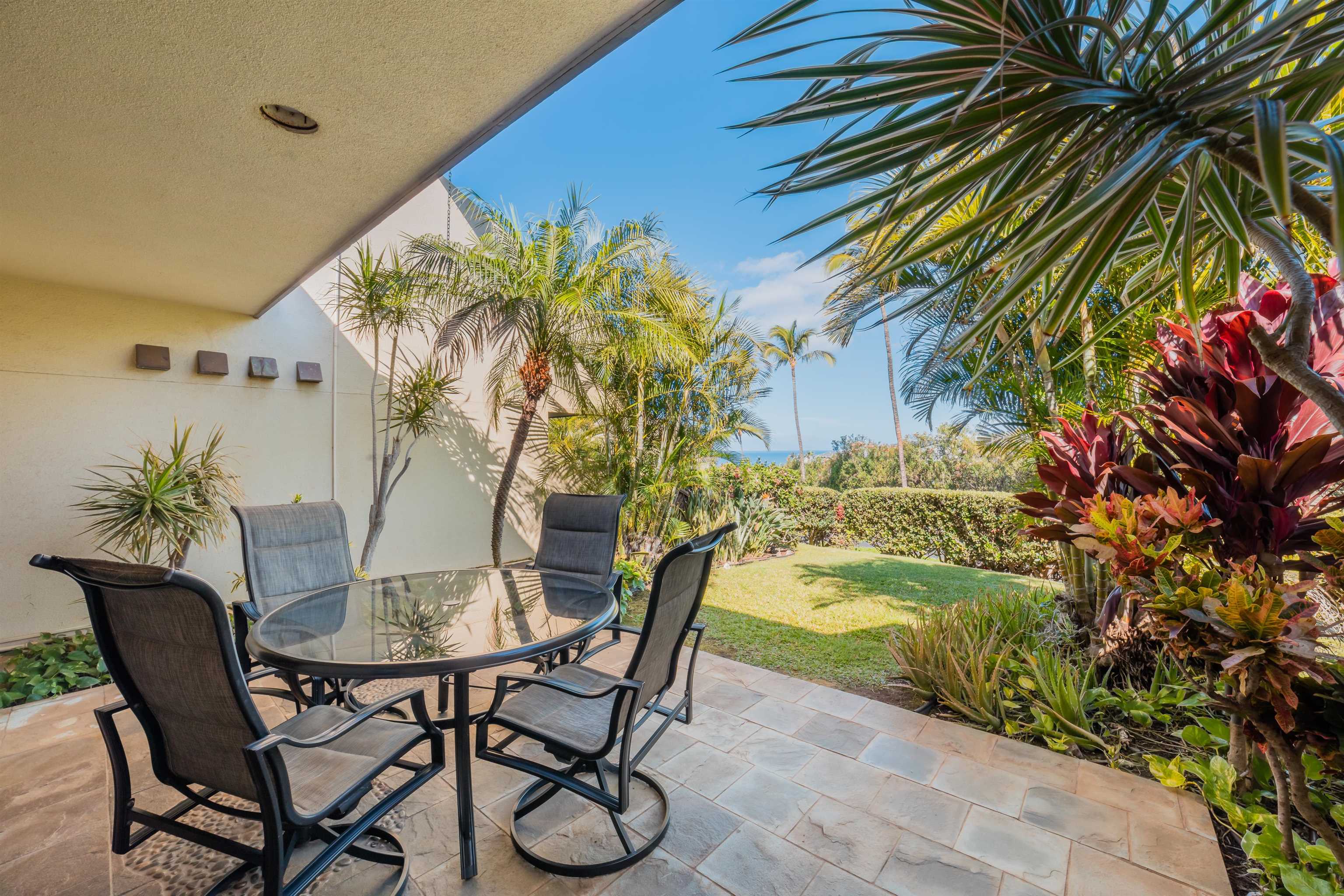 a view of a backyard with a table and chairs