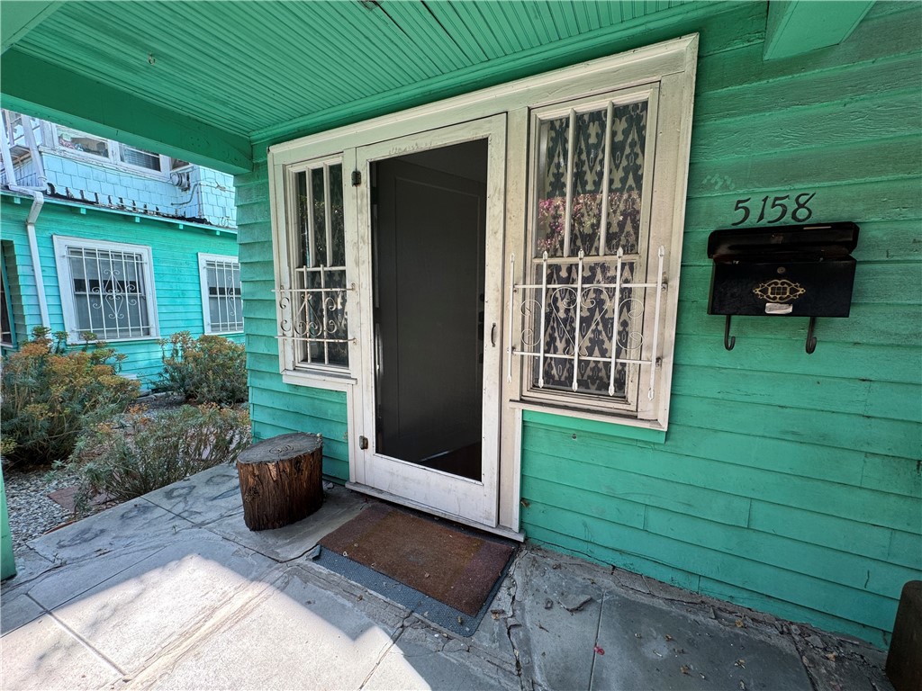 a view of front door and potted plants