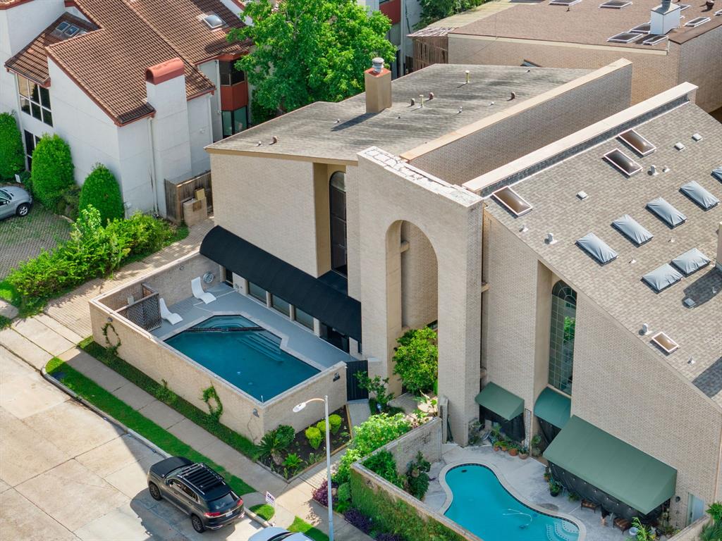 a aerial view of a house with a yard table and chairs