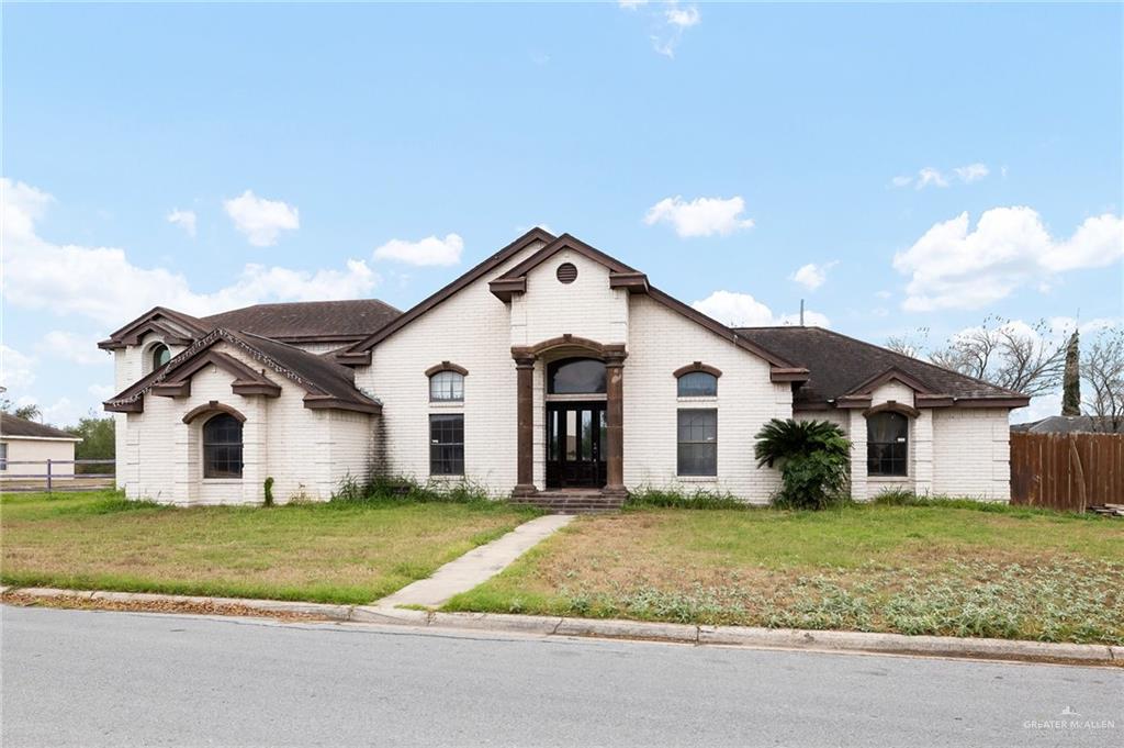 French provincial home featuring a front lawn