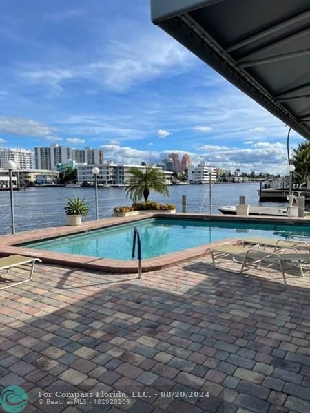 a view of a swimming pool with an outdoor seating