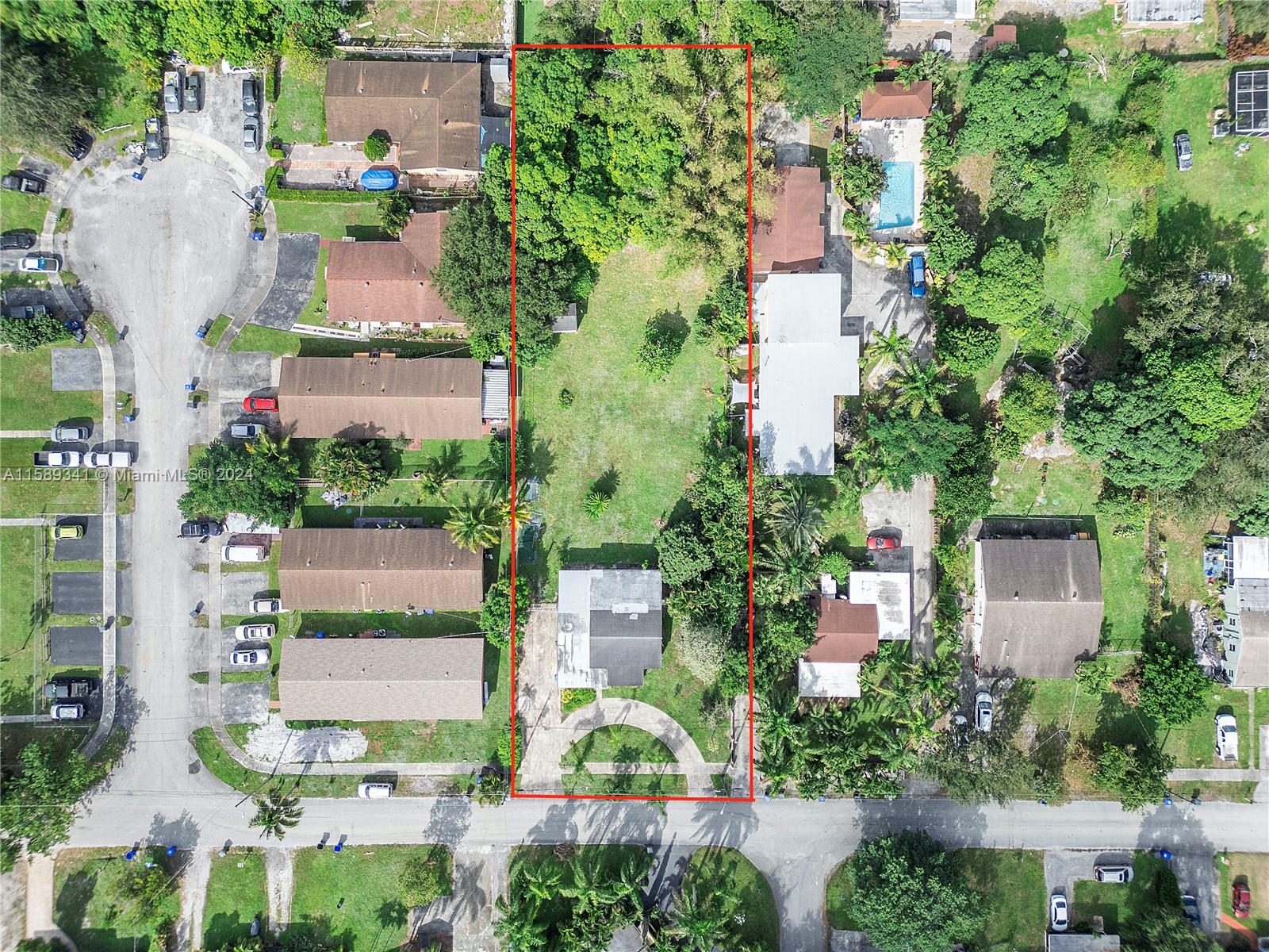 an aerial view of residential houses with outdoor space and street view