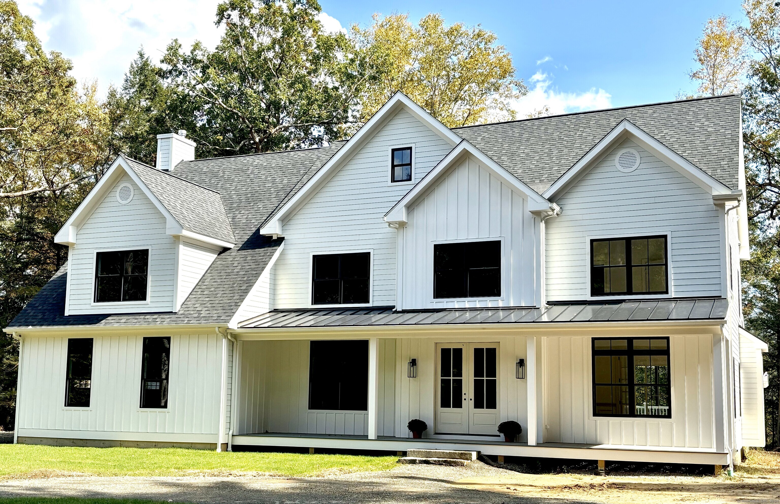 a view of a large white house with large windows