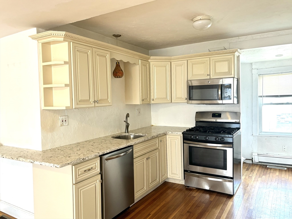 a kitchen with stainless steel appliances granite countertop a stove and a sink