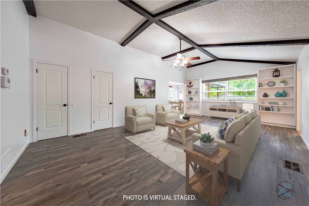 a living room with furniture window and wooden floor