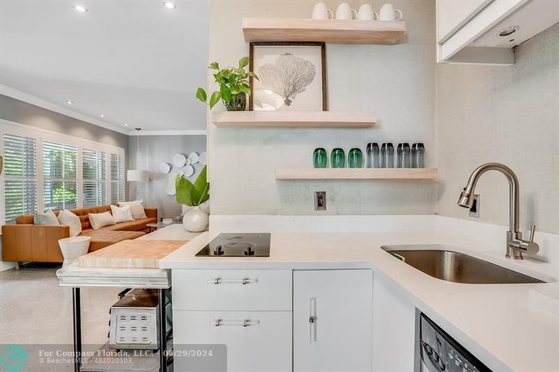 a kitchen with a sink a counter and cabinets