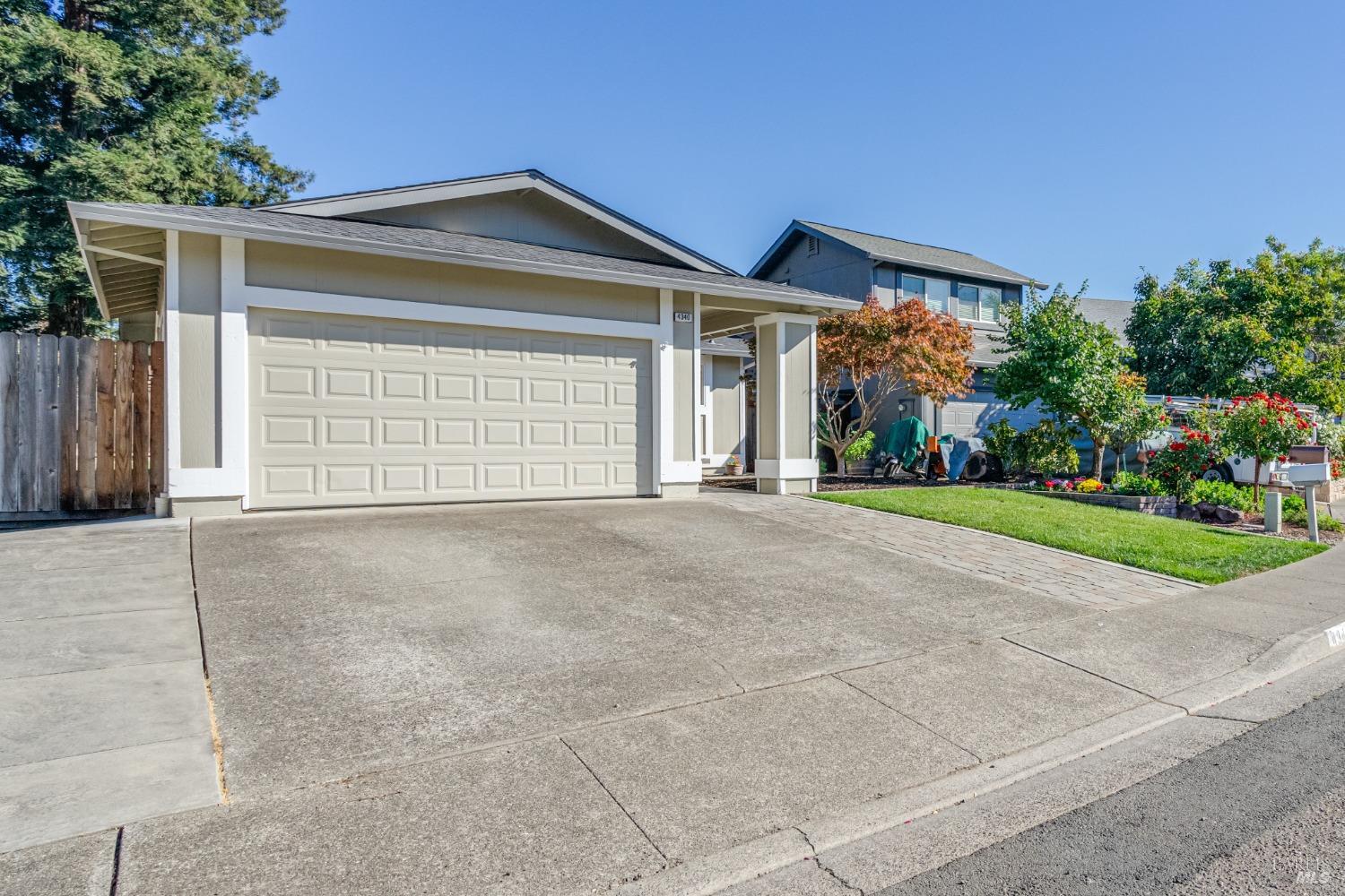 a view of a house with a yard and garage