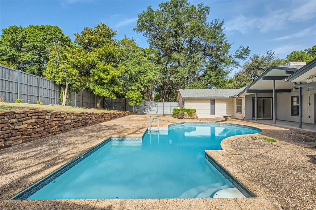 swimming pool view with a seating space