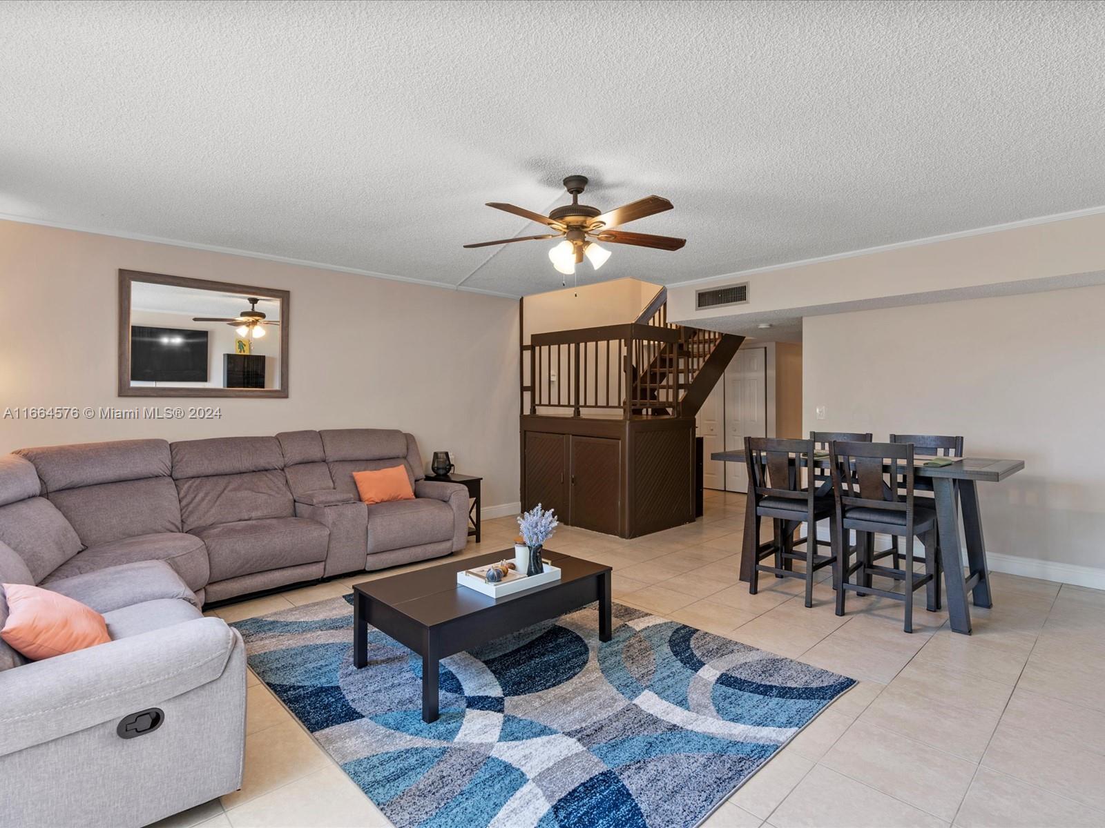 a living room with furniture a table and a chandelier