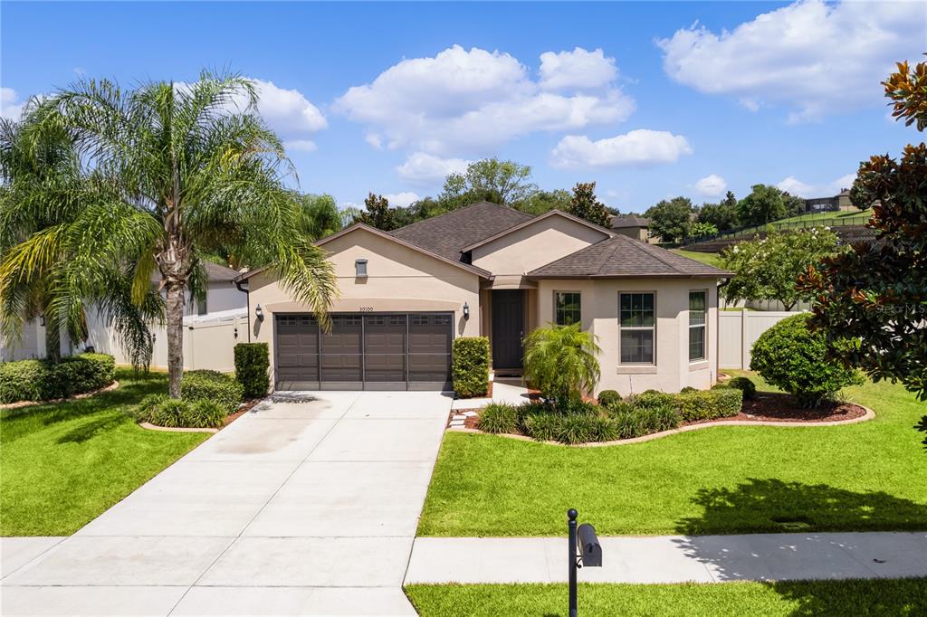 a front view of a house with a yard and garage