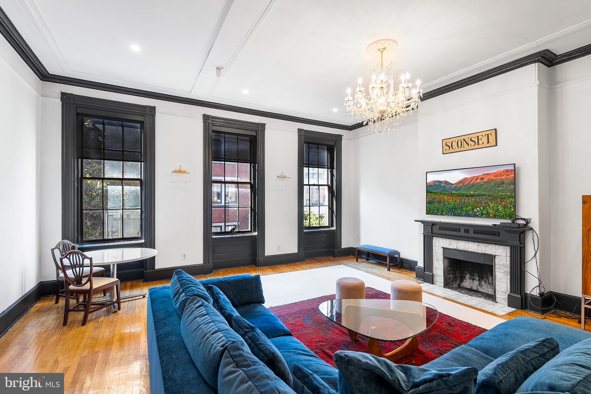 a living room with furniture a fireplace and a flat screen tv