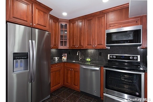 a kitchen with stainless steel appliances granite countertop a refrigerator stove and microwave