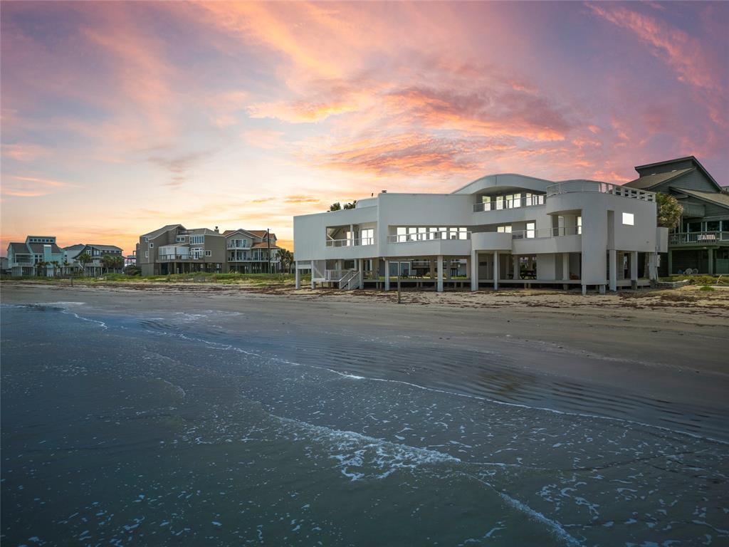 This modern, one of a kind, two-story beachfront home offers dramatic panoramic ocean views from every angle. The home features a sleek rounded architectural design, loaded with windows throughout.