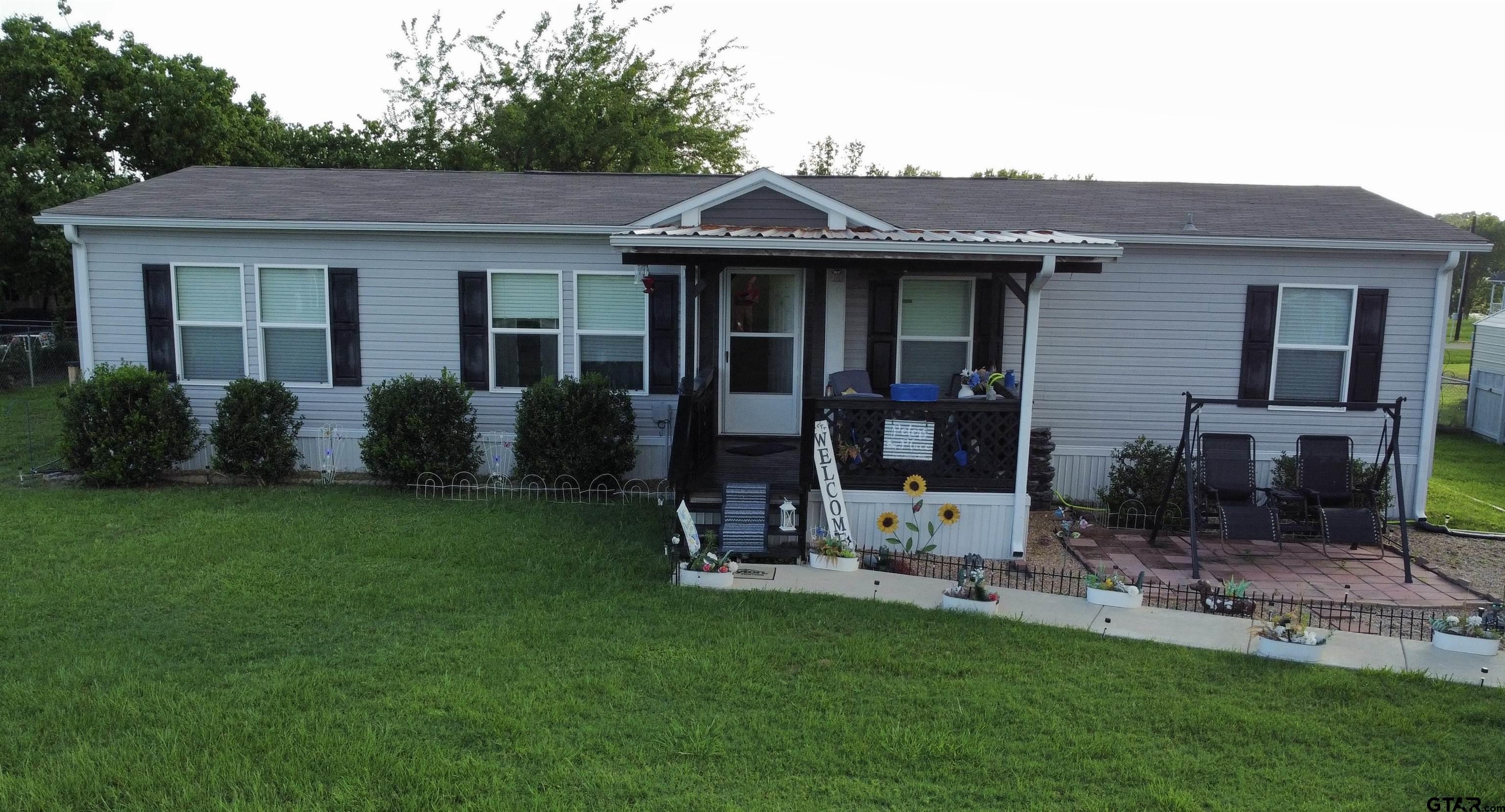 a view of a house with a yard and plants