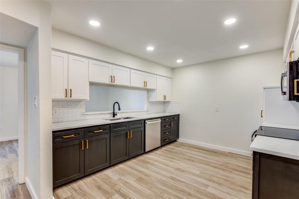 a kitchen with a sink and cabinets