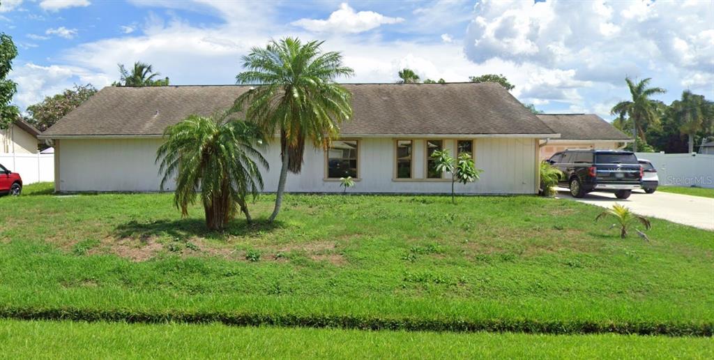 a front view of house with yard and green space