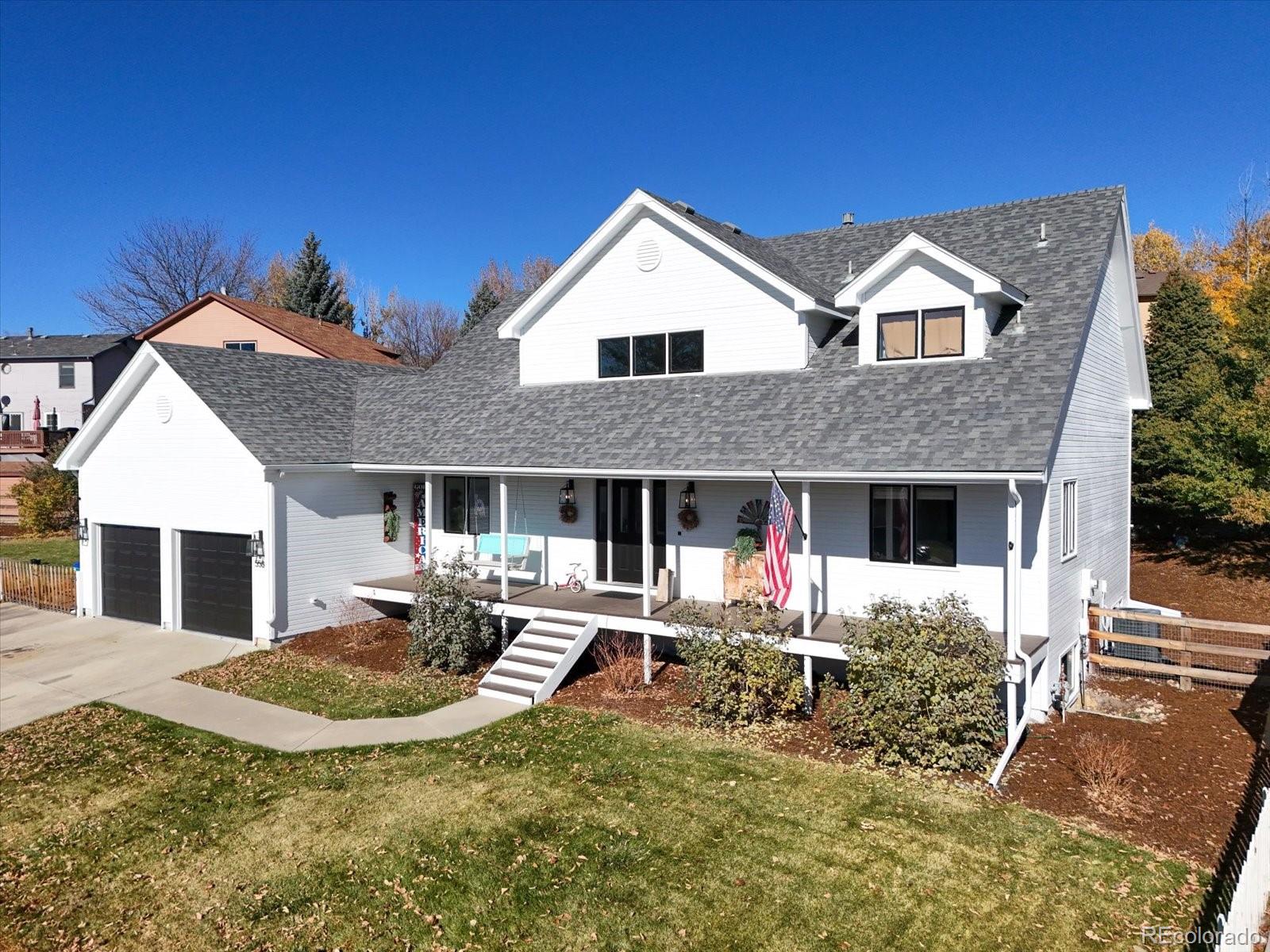 a view of house with yard and sitting area