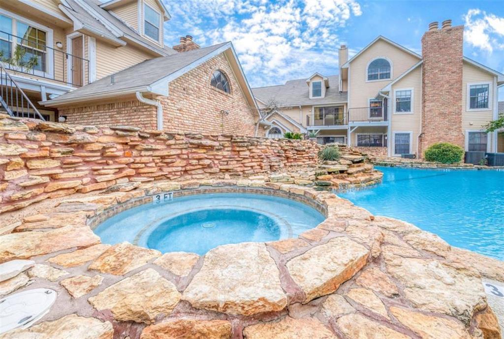 a view of a house with pool and chairs