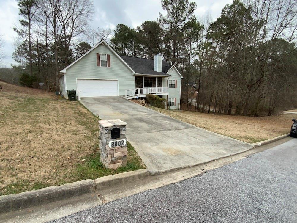 a view of a house with a yard covered with snow in front of it