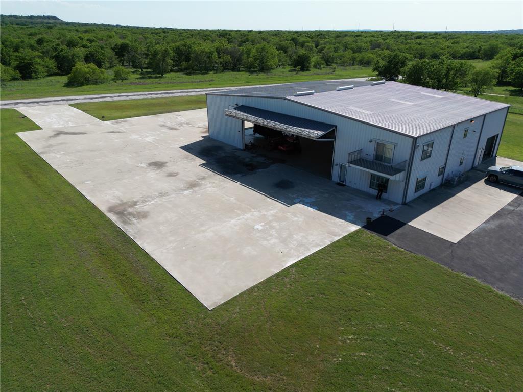 a aerial view of a house next to a big yard