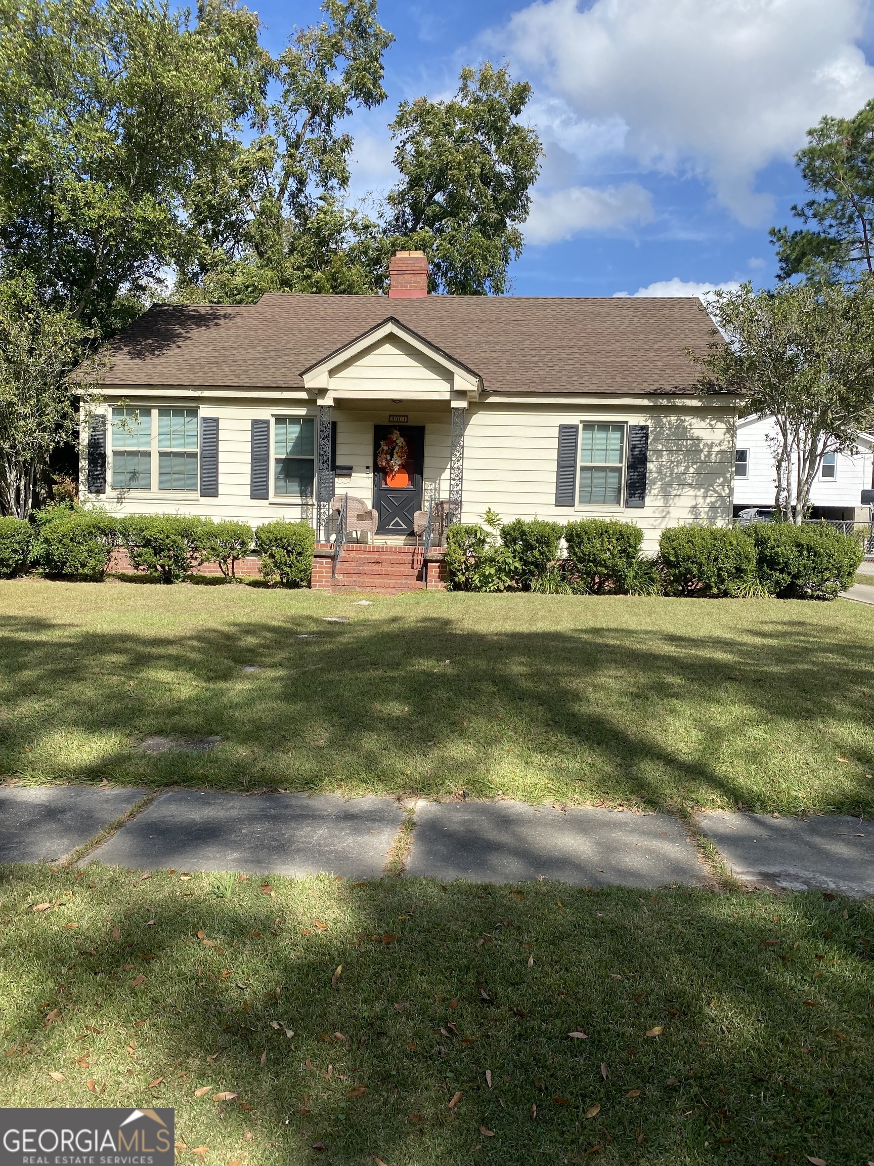 a front view of a house with a garden