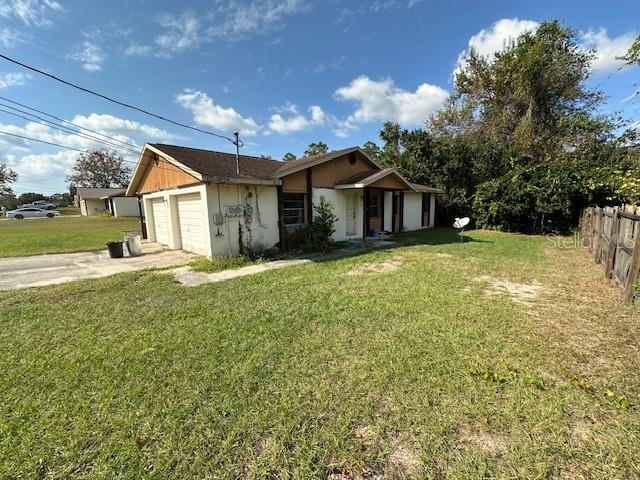 a view of a house with a yard and garage