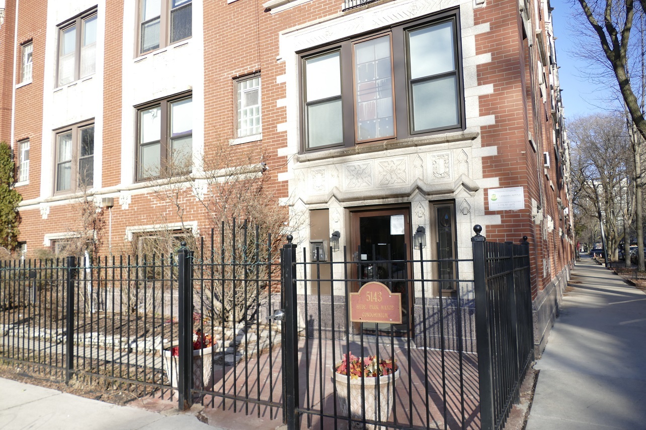 a view of a brick house with many windows