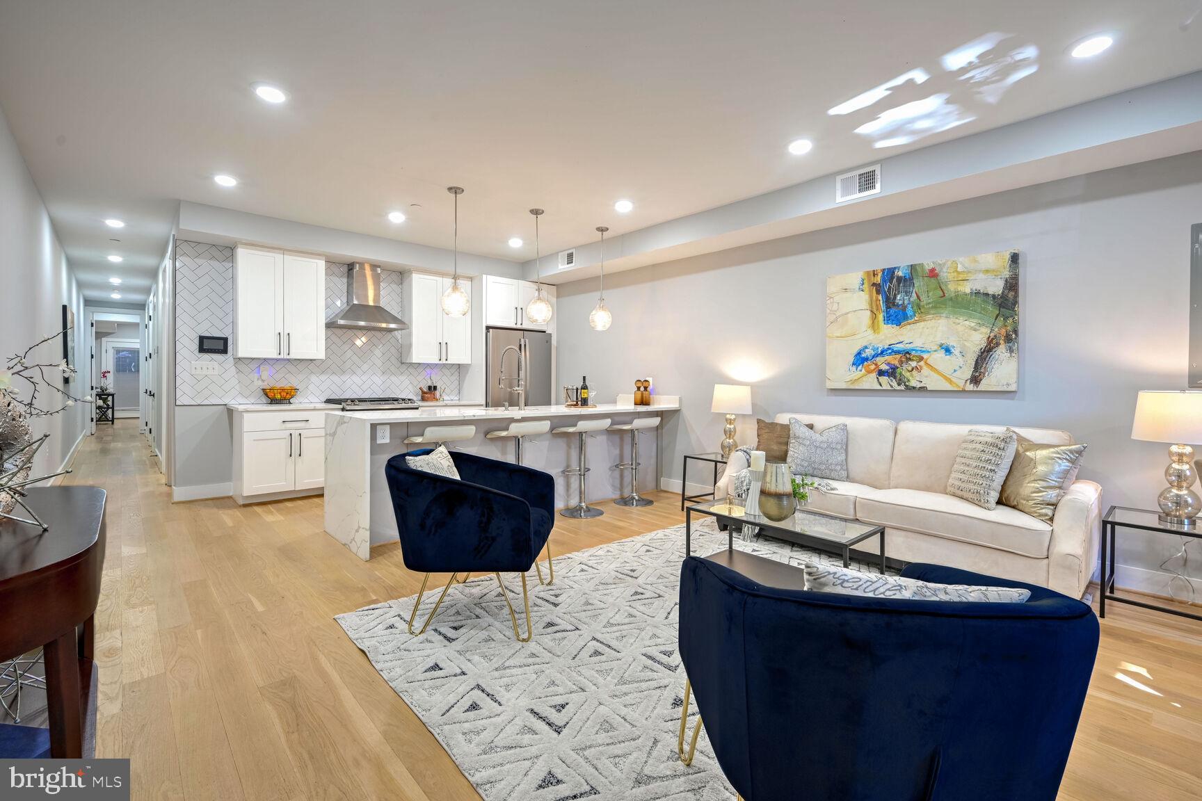 a living room with a couch and a view of kitchen