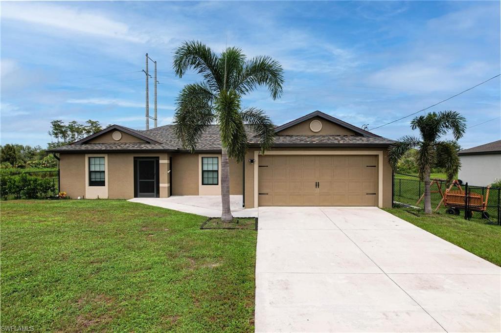 a front view of a house with a yard and garage