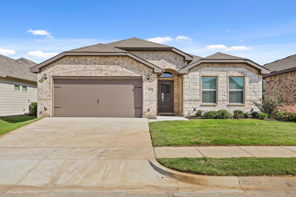 a front view of a house with a yard and garage