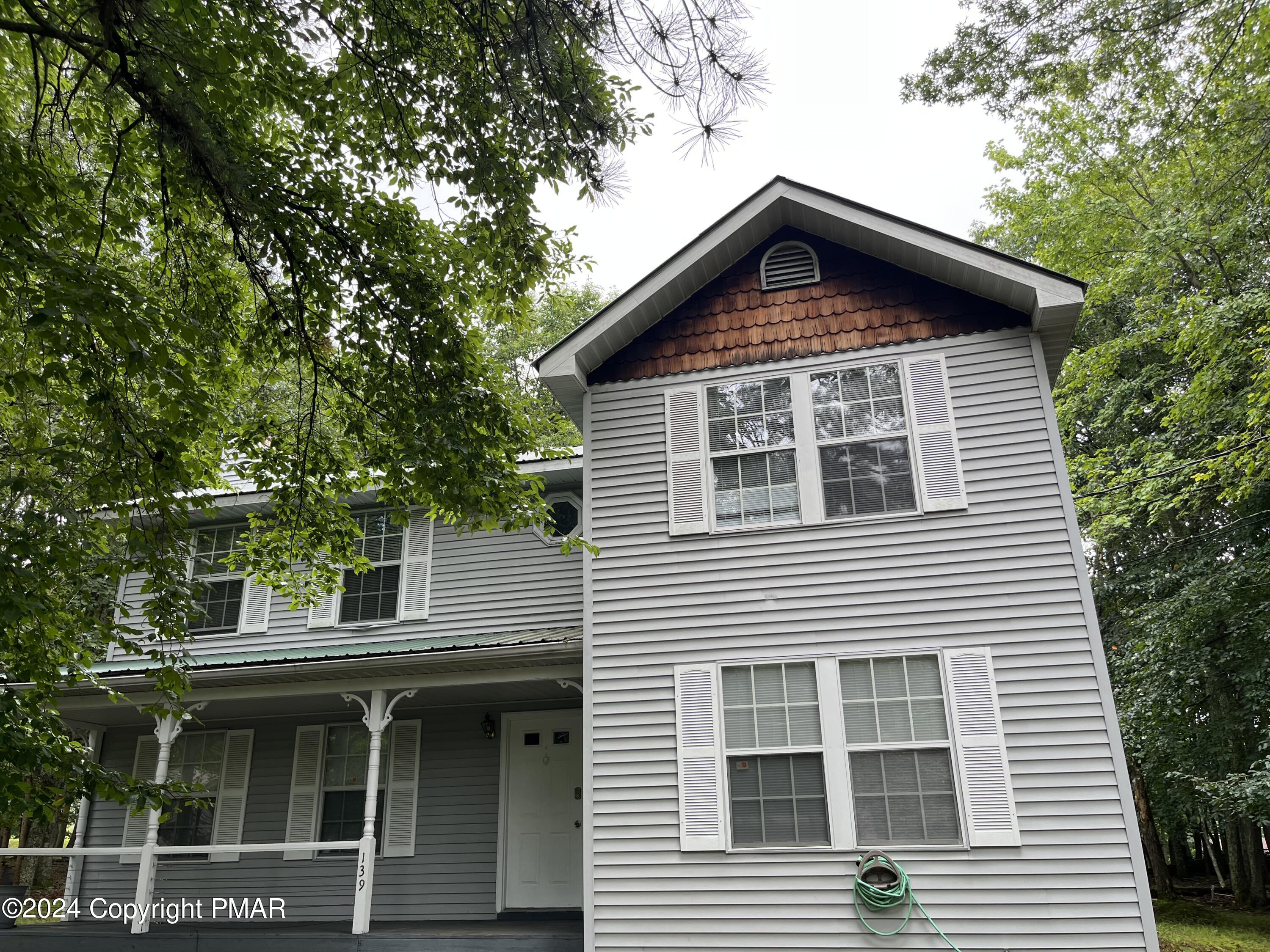 a front view of a house with a garden