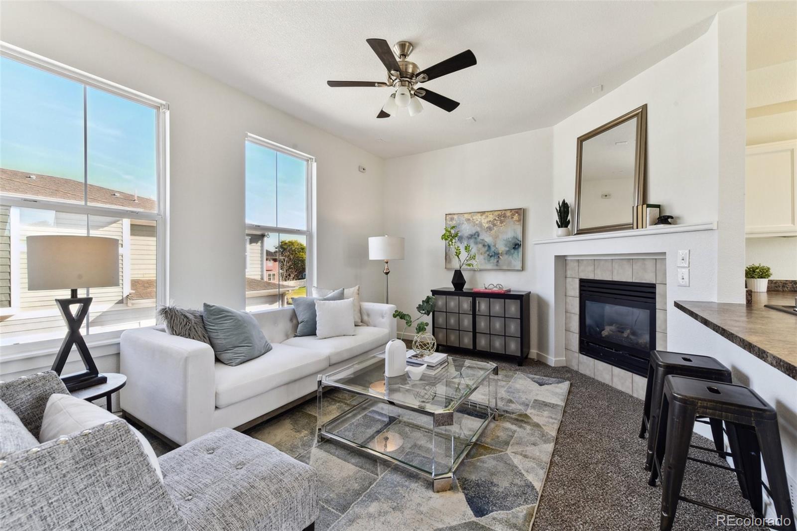 a living room with furniture and a fireplace