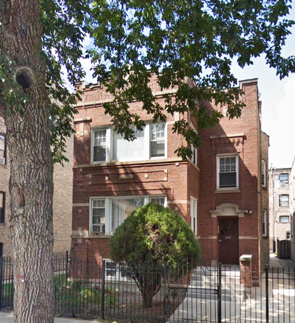 front view of a house with a tree