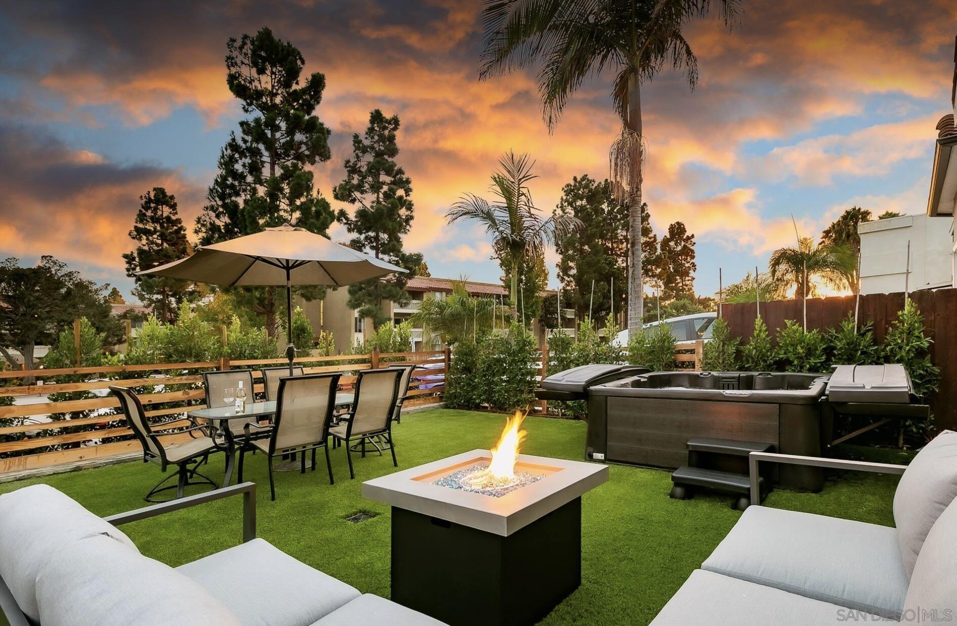 a view of a backyard with sitting area