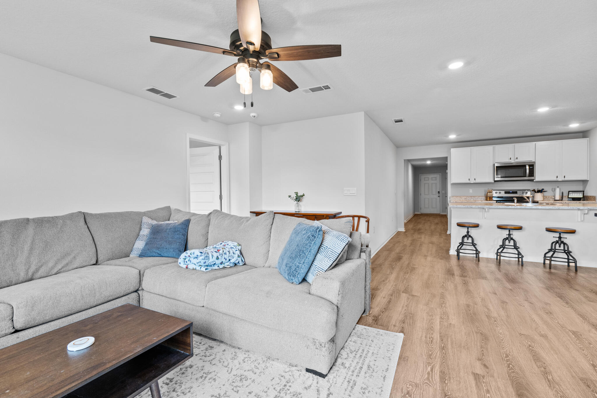 a living room with furniture and a wooden floor