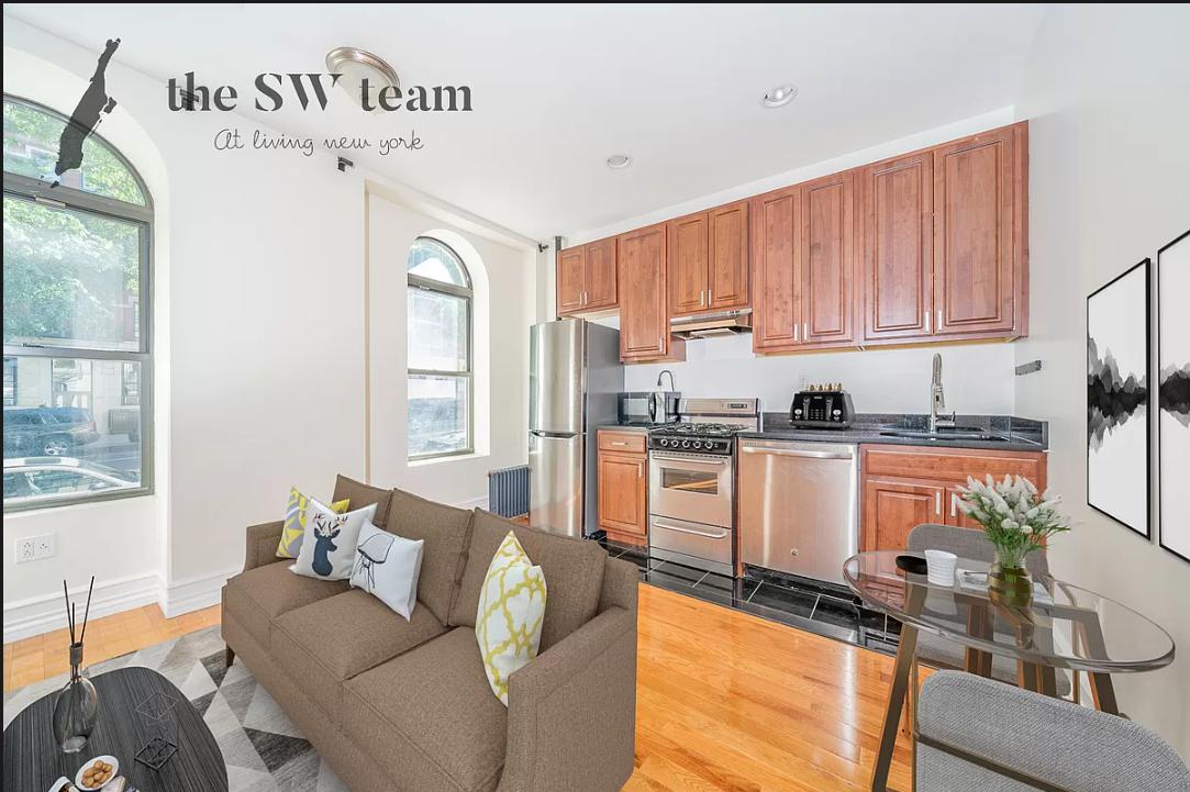 a kitchen with granite countertop a stove a sink and a refrigerator